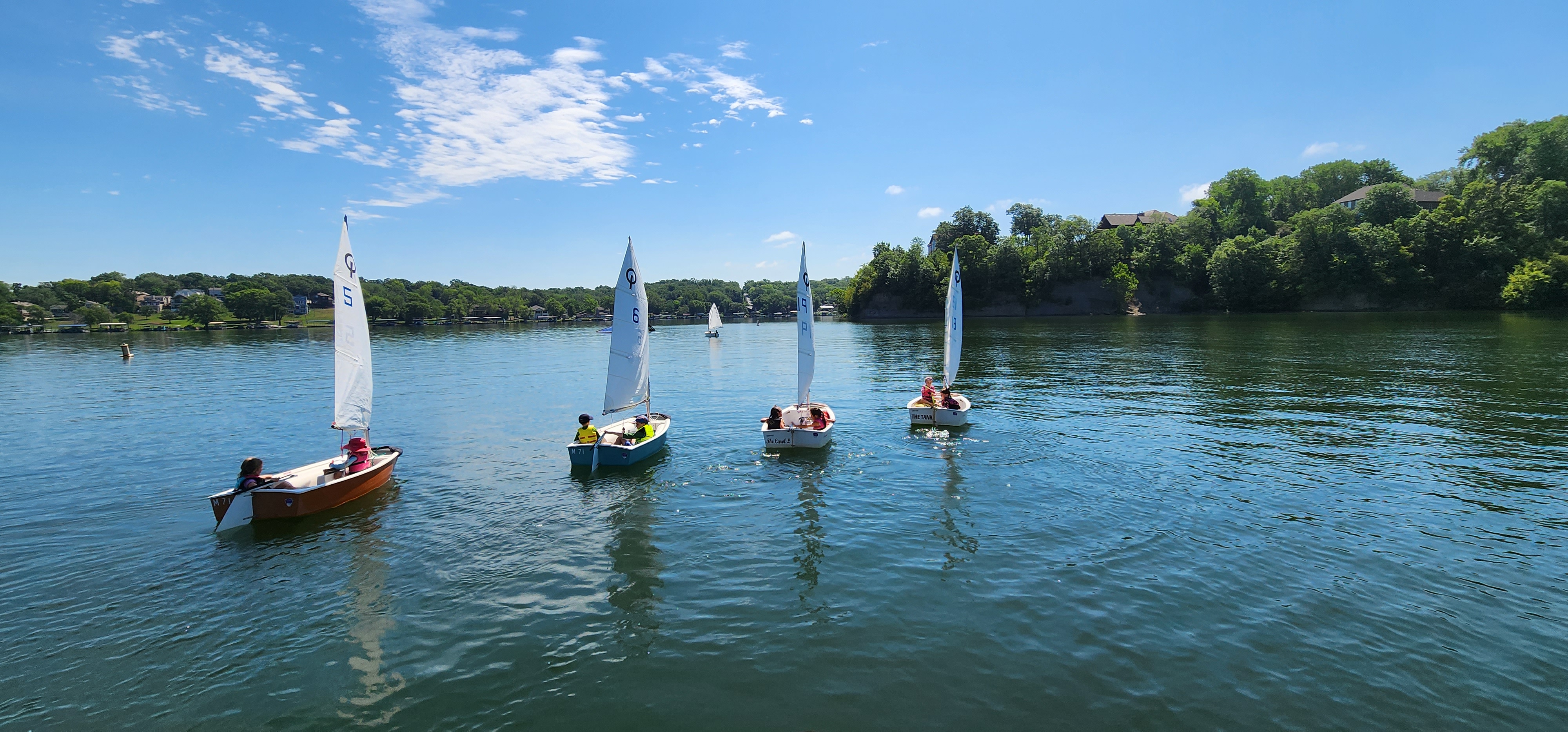Kids sailing Optimist dinghies on Lake Lotawana